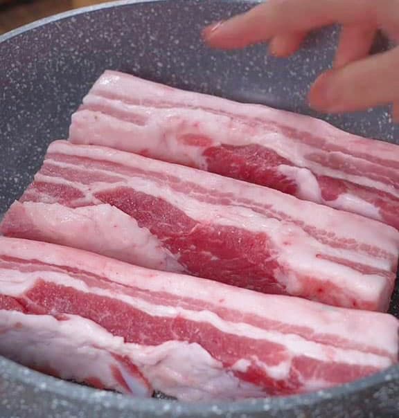 In either a pot or a pan place the pork belly
