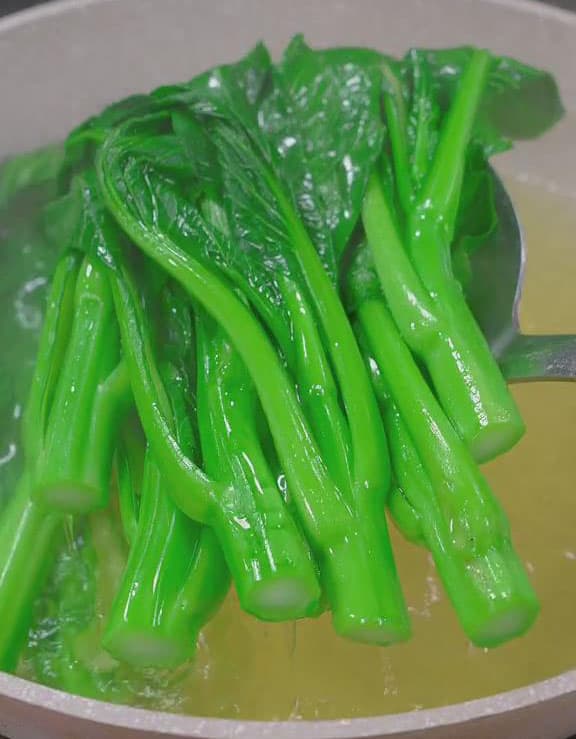 Remove the yu choy from the boiling water and drain