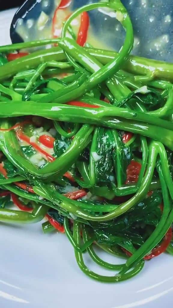 Transfer the delicious water spinach stir fry to a plate