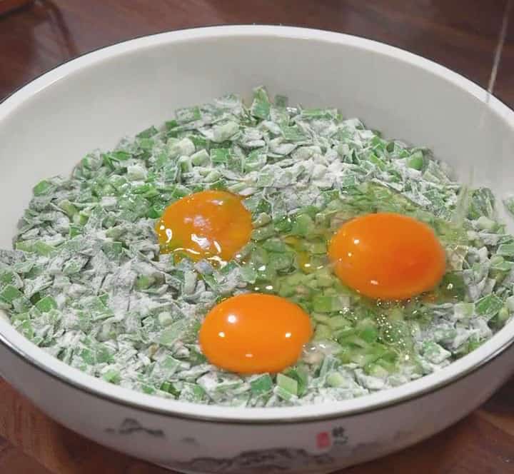 Crack the eggs into the chive mixture