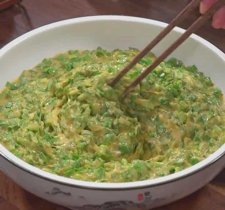 Stir vigorously with chopsticks until a thick cohesive batter forms