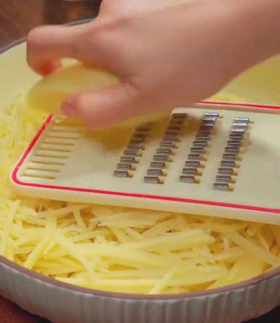 Use a grater to shred the potatoes into thin strips